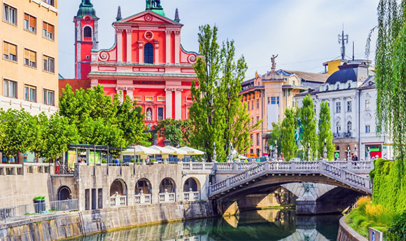 A picturesque view of a canal in a city centre within Slovenia.