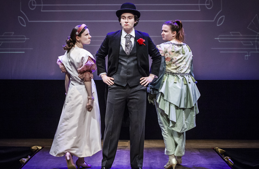 Three performers wearing handmade gowns and suits in the 2024 Costume Showcase