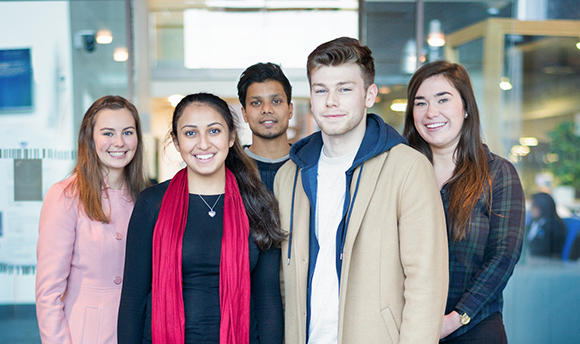 A photo of a group of QMU students looking directly at the camera and smiling