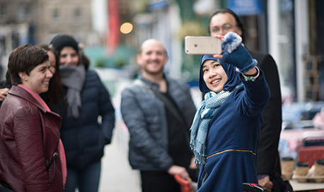 A group of friends pose whilst another snaps a photograph, Edinburgh City Centre