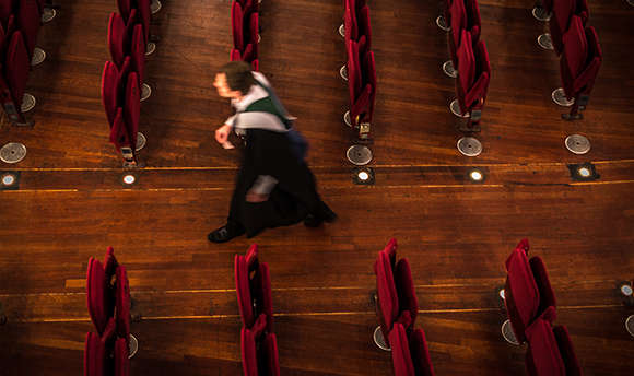 A QMU graduate walking down the aisle at Usher Hall, Edinburgh