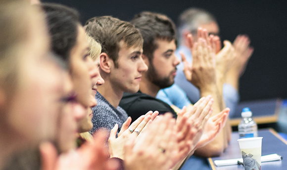 Row of students in QMU lecture hall applauding the speaker, Edinburgh