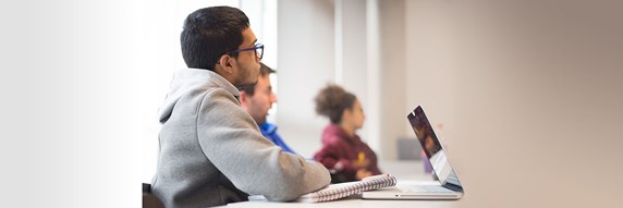 A small group of Queen Margaret University students listening in class