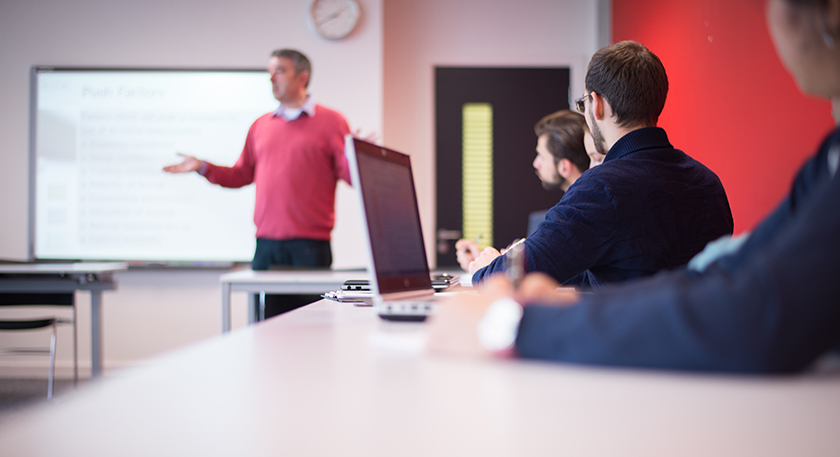 QMU Students in class listening to a lecturer