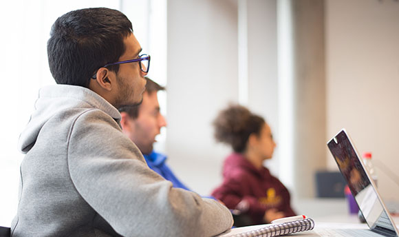 A small group of Queen Margaret University students listening in class