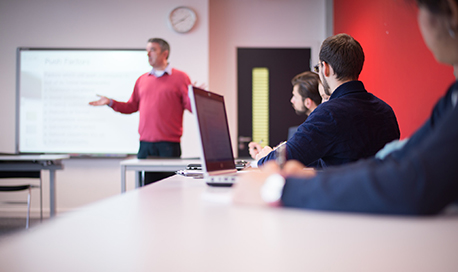 A small group of Queen Margaret University students listening in class