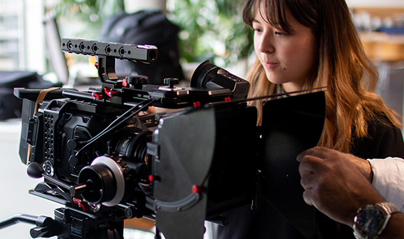 A Queen Margaret University Student working with a professional high end camera