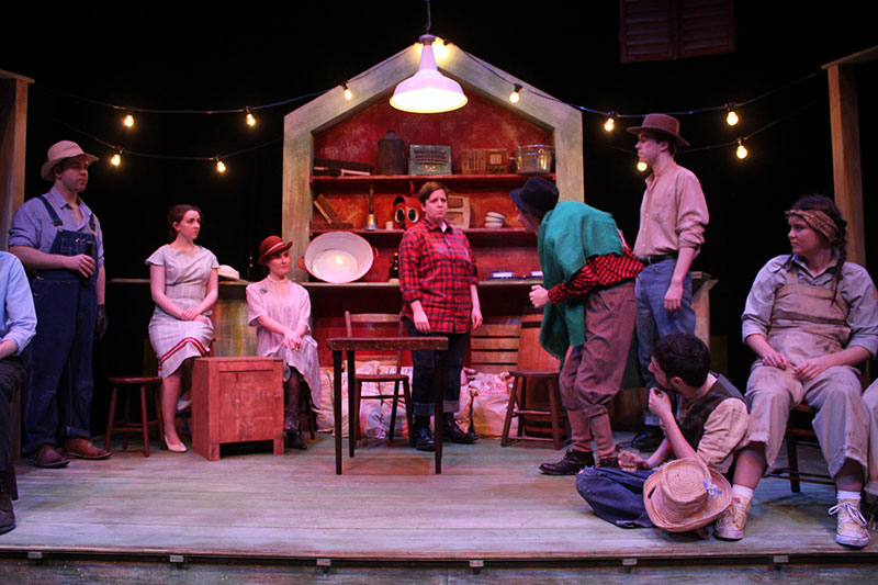 QMU students during a dramatic performance dressed as southerners in overalls