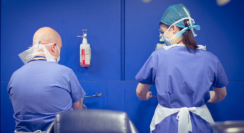 Two Podiatry students wearing PPE and washing their hands