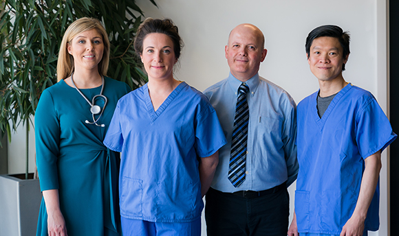  Four advancing practice in health students looking into the camera. 