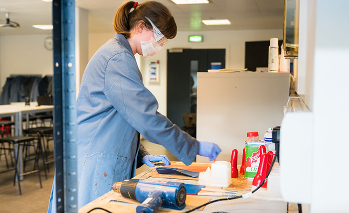 A Queen Margaret University student making shoe insoles