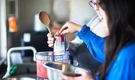 Queen Margaret University Dietetics student placing a strawberry in a blender