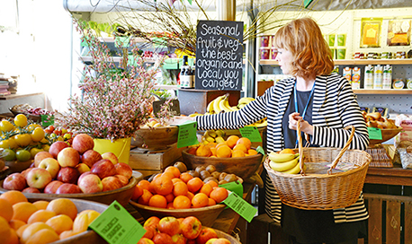 Person picking produce from a fruit shop