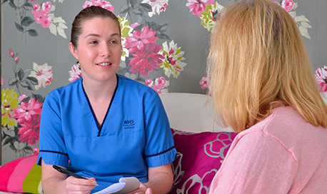 A student nurse talking to a patient