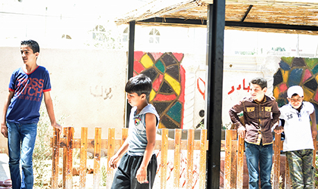 Four children standing outside in the sun