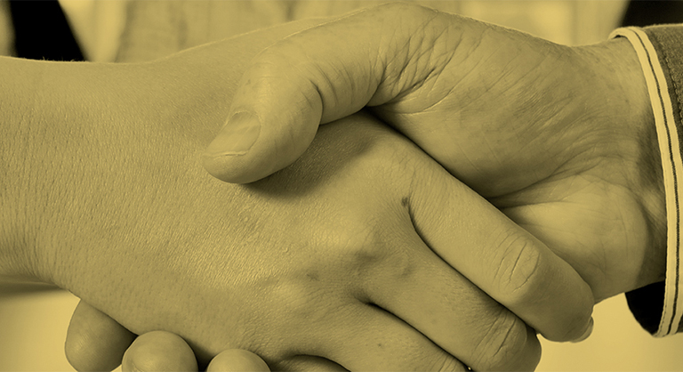 B+W close up photo of two people shaking hands