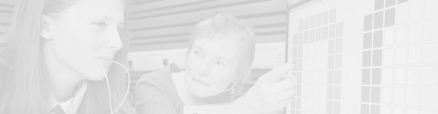 A young girl using the speech and language therapy equipment with a woman