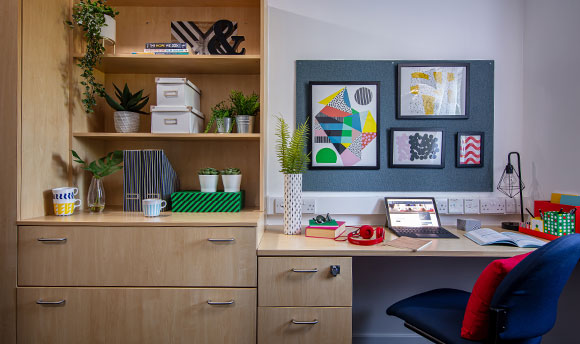 A desk and some shelves in Queen Margaret University campus accommodation