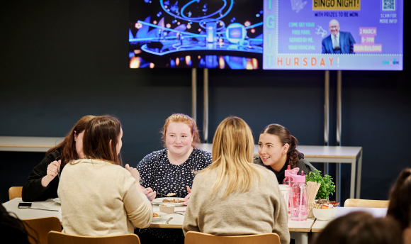 A group of QMU students sat round a table