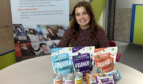 Fodilicious founder Lauren Leisk poses with an assortment of Fodilicious brand products at QMU's Business Gateway.