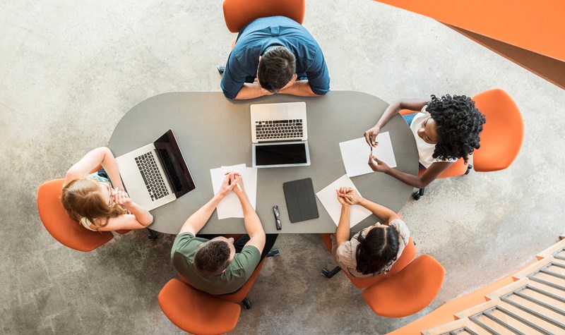 Students working together in a group around a table