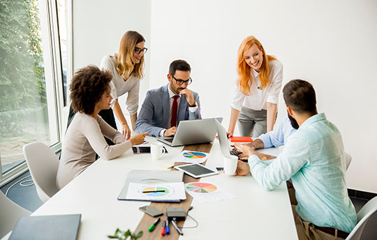 Business people sitting around a desk