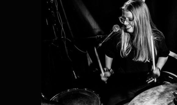 QMU graduate Katie Slater playing the drums