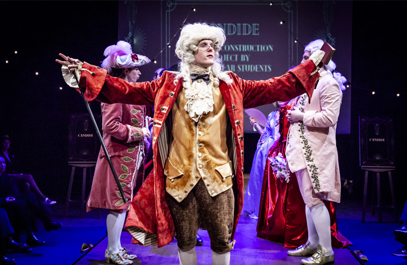 Three performers wearing handmade regency-style outfits in the 2024 QMU Costume Showcase.