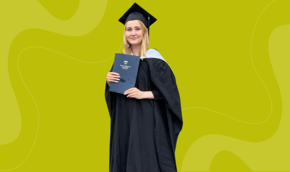 QMU student Neea Nieminen at graduation holding her diploma