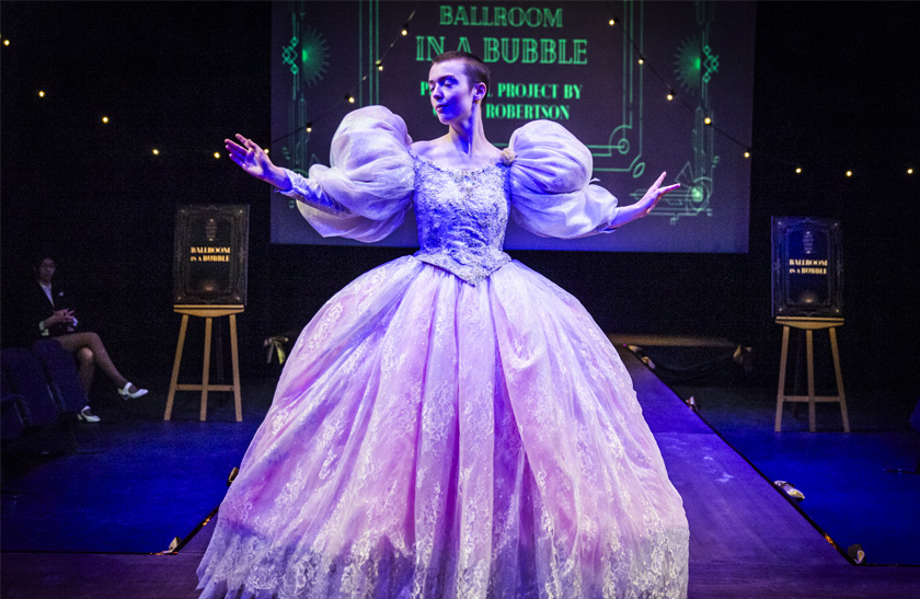 A performer wearing a hand-crafted ballroom gown from the 2024 QMU Costume Showcase.