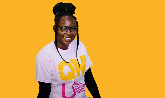 Girl smiling in QMU t-shirt