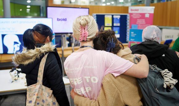 Two QMU students hugging