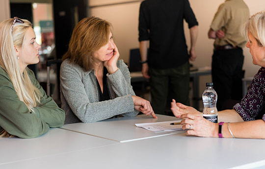 Student and parent discussing complaint with university staff 