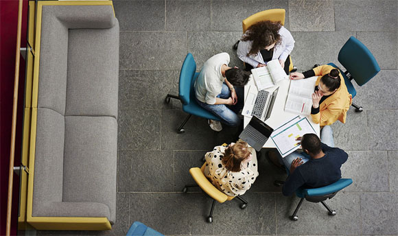 A group of business students sat around a desk